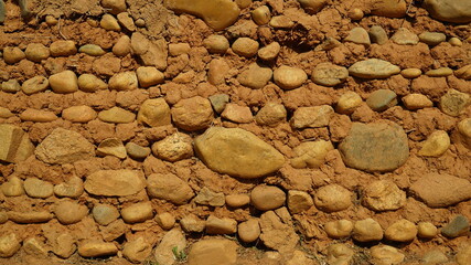 The outer wall of an oriental traditional building made of ocher and rocks