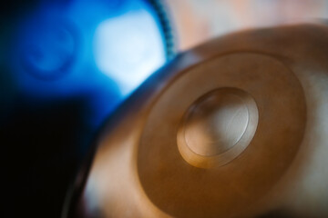 A close-up view of a musical instrument called a handpan, also known as a hang or pantam.
