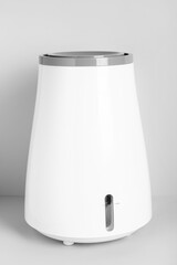 Modern humidifier on grey background