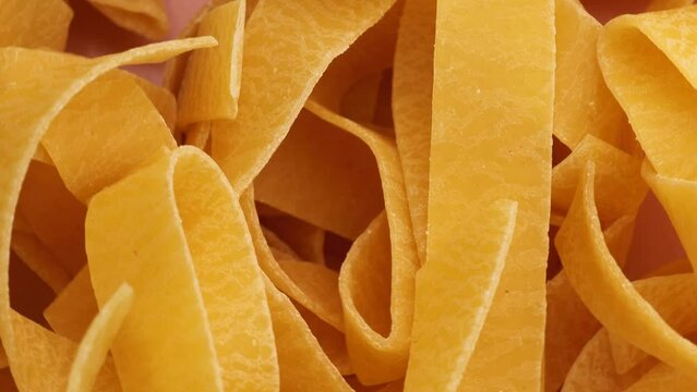 dry pappardelle pasta, rotation in circle. handmade pasta, Turning. selective focus