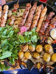 Assorted: shish kebab from poultry, pork, shrimps, vegetables, potatoes