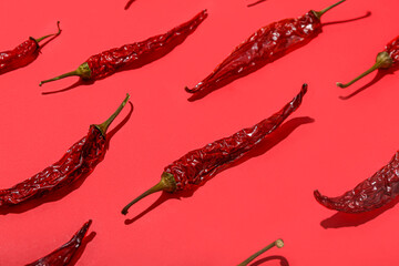Dry hot chili peppers on red background
