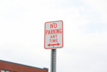 No Parking sign on a city street, representing order, restriction, and urban regulations. Symbolizes vehicular control and maintaining orderly spaces