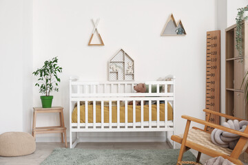 Interior of children's bedroom with crib, shelves and toys