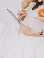 happy teenage girls friend using mobile phone for online shopping in bedroom