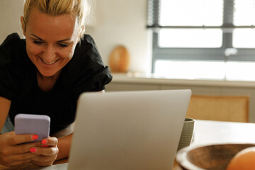 Fototapeta premium A woman is writing a business plan in her dining room