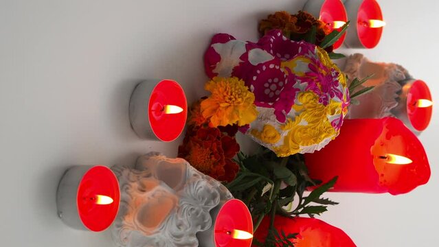 Vertical video for Day of the Dead. Traditional Mexican altar to the memory of the dead - sugar skull, candles and orange flowers