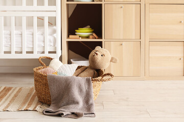 Basket with knitted toys in children's room