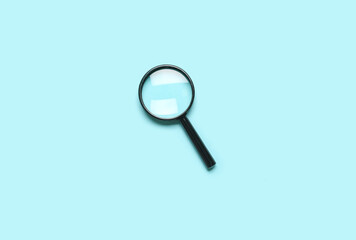 Black mini magnifier on blue background