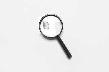 Magnifier and paper with fingerprint on grey background. Detective concept