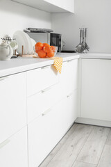 White counters with food and utensils in kitchen