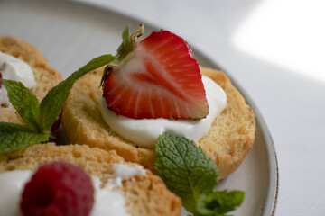 Bread with strawberries, mint on a light background
