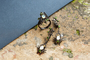 Elegant jewelry set. Jewellery set with gemstones. Jewelry accessories collage. Product still life concept. Ring, necklace and earrings.