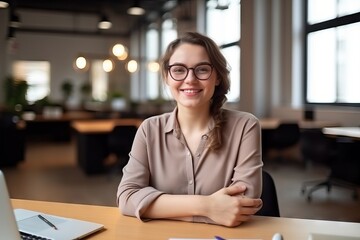 happy woman looking at camera while sitting at office
