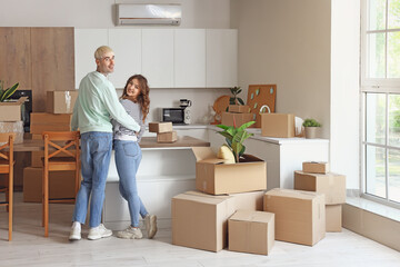 Fototapeta na wymiar Young couple hugging in kitchen on moving day