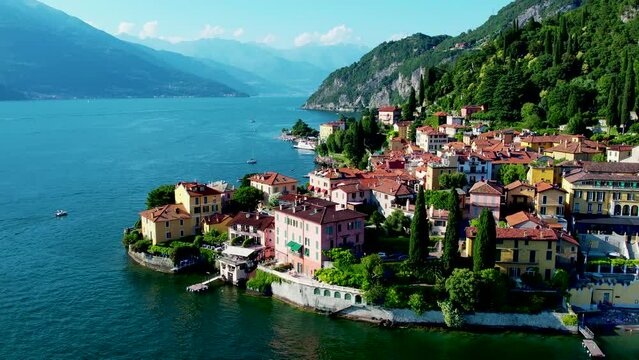Aerial 4K footage of Varenna, Como Lake. Drone panoramic view of town surrounded by mountains, blue sky and turquoise water and located in Como Lake, Lombardy, Italy