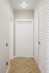 Hallway with white interior doors in the interior