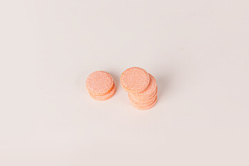 Yellow vitamin c tablet supplements isolated on a white background