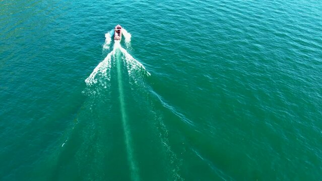 Aerial 4K footage of a classic old wooden luxury fast sailing boat in Lake Como