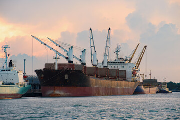 Cargo ship loading containers at sunshine