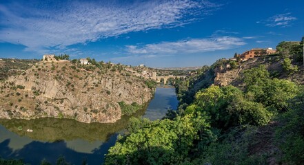 Fototapeta premium toledo, spain, tajo, river, bridge, summer, heat, sunny, sky, blue, architecture, city, town, landscape, building, village, europe, view, travel, house, italy, ancient, old, medieval, tourism, panoram