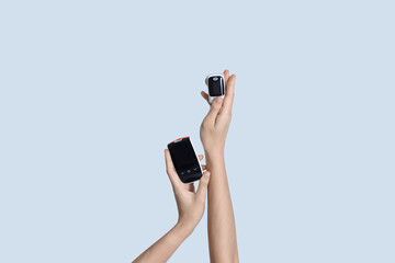 Female hands holding digital medical equipment on grey background