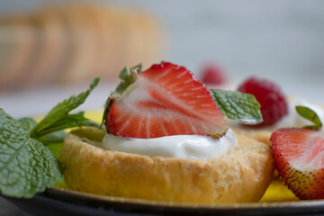 Bread with strawberries, mint on a light background