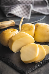 Smoked scamorza cheese on cutting board.
