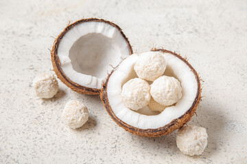 Coconut with white chocolate candies on light table