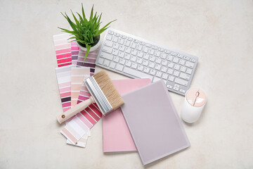 Many color palettes, PC keyboard, brush and notebooks on light background, top view
