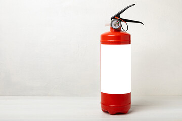 Fire extinguisher on a white texture background. Fire protection, home fire extinguisher. home...