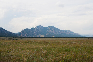 a field of grass near mountains