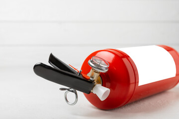 Naklejka premium Fire extinguisher on a white texture background. Fire protection, home fire extinguisher. home security concept. Place for text. Copy space.banner