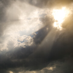 Sunbeams through storm clouds.