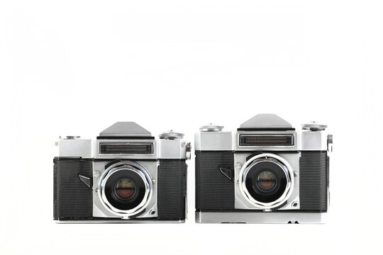 Very rare old 35 mm SLR cameras on white background.