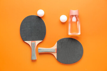Ping pong rackets and balls on color background