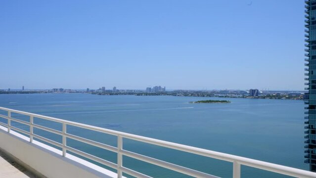 White penthouse balcony with amazing scenery on Venetian Islands in Miami Beach. Luxury modern estate property with stunning ocean view. Concept of tourism and summer vacation