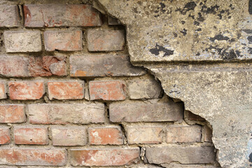 Old brick wall with destroyed plaster. Texture