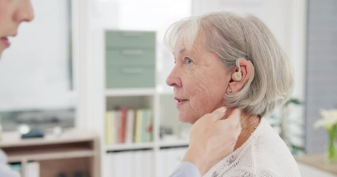 Consultation, doctor and hearing aid for senior woman at clinic for help with ear problem. Hearing, treatment and installation with elderly female for listening with medical expert for solution.