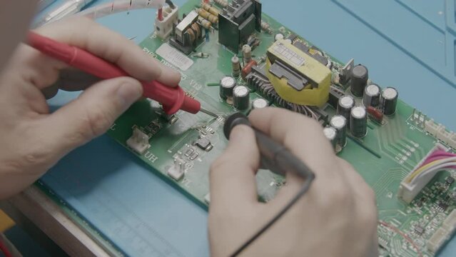 The wizard uses an electronic tester to test the components on the computer board
