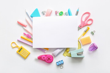 Composition with blank paper sheet and different school stationery on white background