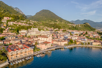 Fototapeta na wymiar Marone, Lake Iseo. Aerial panoramic sunset view of Marone town surrounded by mountains and located in Iseo Lake, Brescia, Lombardy, Italy