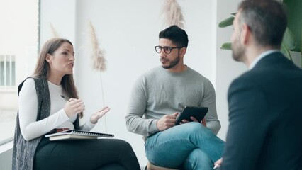 Video of smart entrepreneurs working while talking in a meeting on coworking space.