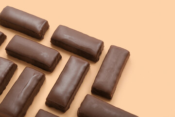Tasty chocolate covered coconut candies on yellow background