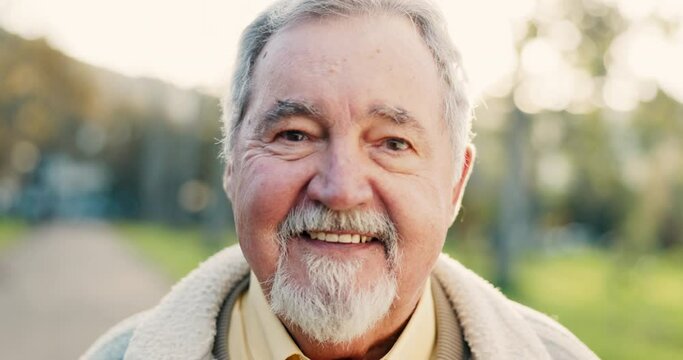 Happy, senior man and portrait outdoor in a park with happiness, positive mindset and a smile. Face of elderly male person in nature, forest or woods for fresh air, health and wellness in retirement