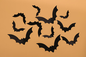 Paper bats for Halloween party on beige background