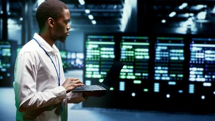 Engineer walking through cryptocurrency mining facility server rows solving complex mathematical equations. Expert in data center housing blockchain technology high volume real time transactions - Powered by Adobe