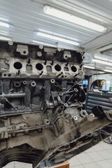 Car engine in a repair shop for overhaul and spare parts replacement.