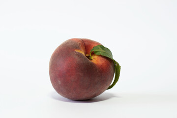 Single peach isolated on white background.