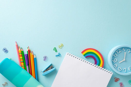 Enhance your educational materials with this top view photograph featuring blank notepad with stationery on pastel blue isolated background. Perfect for promotional purposes and text placement - Powered by Adobe